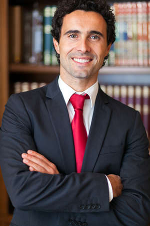 Portrait of an handsome smiling businessman in his officeの写真素材