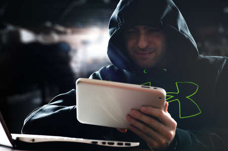 Hacker hacking a digital tablet
