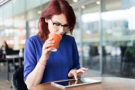 Happy pensive woman thinking in a coffee shop terrace in the streetの写真素材