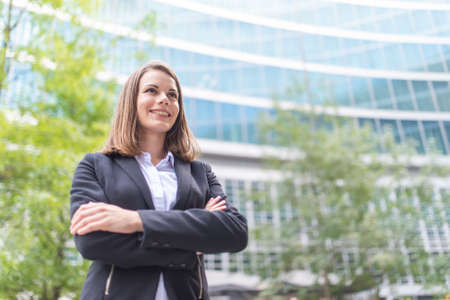 Portrait of a smiling businesswoman in front of her office, work and career conceptの写真素材