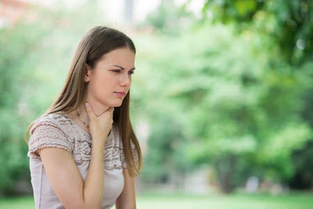 Young woman having sore throatの写真素材
