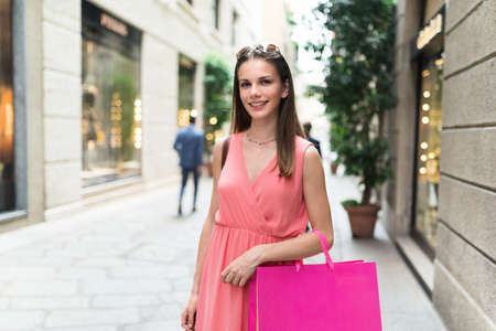 Beautiful woman carrying shopping bagsの写真素材