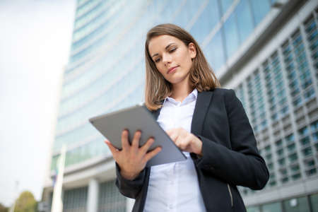 Portrait of a young woman using a tablet out of her officeの写真素材