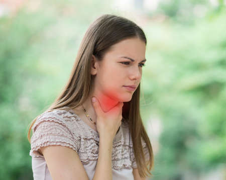 Young woman having sore throatの写真素材