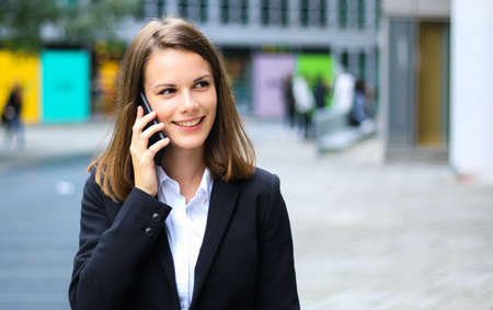 Portrait of a young woman talking on the phoneの写真素材
