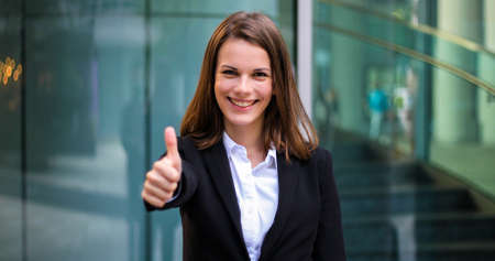 Confident young female manager outdoor in a modern urban settingの写真素材