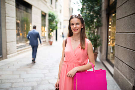 Young woman shopping in a city streetの写真素材