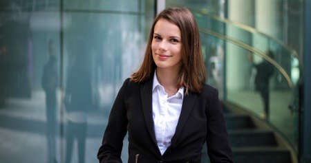 Confident young female manager outdoor in a modern urban settingの写真素材