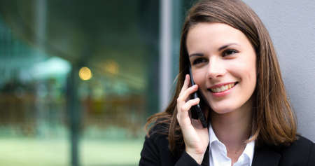 Portrait of a young woman talking on the phoneの写真素材