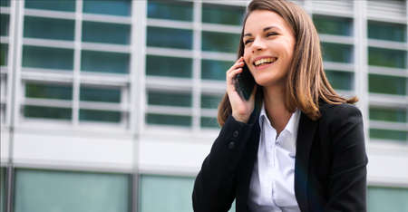 Portrait of a young woman talking on the phoneの写真素材