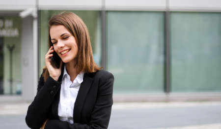 Portrait of a young woman talking on the phoneの写真素材