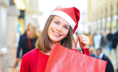 Young woman shopping with a Christmas outfitの写真素材