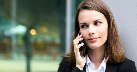 Portrait of a young woman talking on the phoneの写真素材