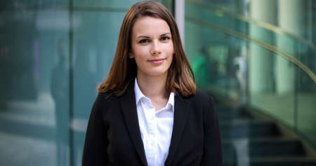 Confident young female manager outdoor in a modern urban settingの写真素材