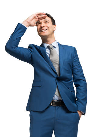 Businessman looking at the horizon, isolated on whiteの写真素材