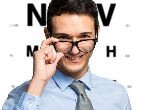 Man taking an eye exam and wearing glassesの写真素材