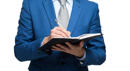 Businessman taking note using pen and notepadの写真素材