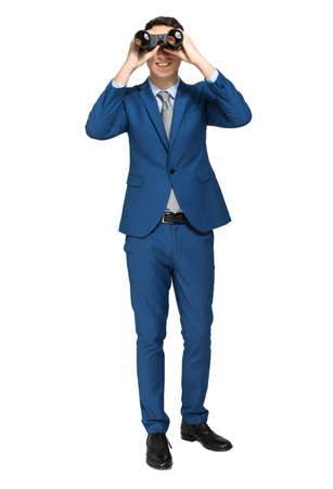 Businessman looking through binocularsの写真素材