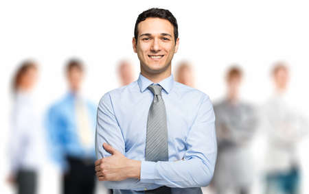Friendly business leader in front of his teamの写真素材