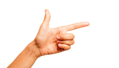 Woman's hand making shooting gun, gesture. hand pistol gesture on isolated white background. Woman hand pointing with two fingersの写真素材