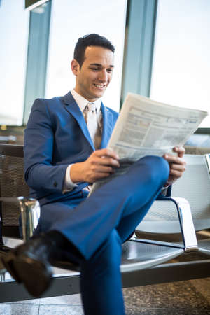 Sitting businessman reading a newspaperの写真素材