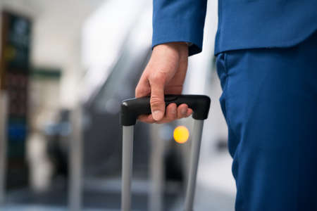 Detail of a businessman pulling a trolley in an airportの写真素材