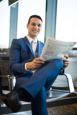 Sitting businessman reading a newspaperの写真素材