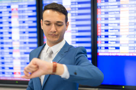Businessman checking time in an airportの写真素材