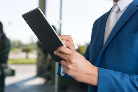 Detail of a businessman using his tabletの写真素材