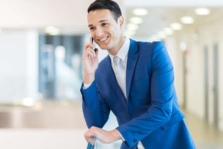 Young manager on the phoneの写真素材