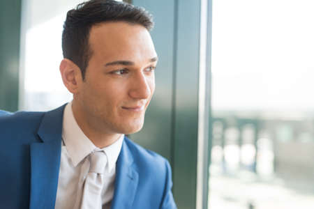 Businessman looking out of the windowの写真素材