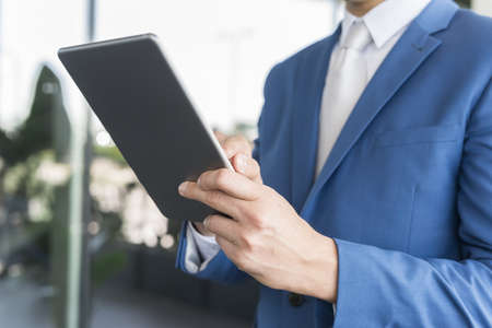 Detail of a businessman using her tabletの写真素材
