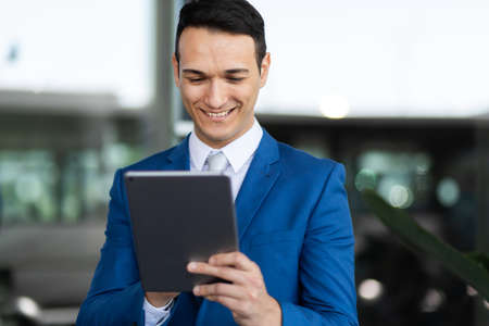 Young manager using a digital tablet outdoorの写真素材