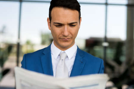 Businessman reading a newspaperの写真素材