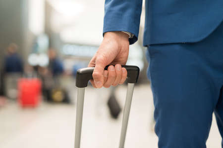 Detail of a traveler pushing his trolleyの写真素材