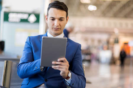 modern businessman using tablet computer at airportの写真素材