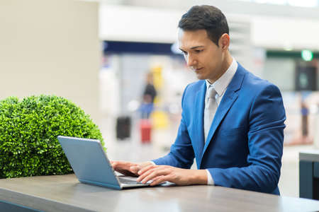 Young businessman working at his laptopの写真素材