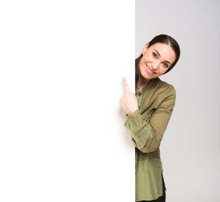 Woman showing a blank panel, space for your text or product imageの写真素材
