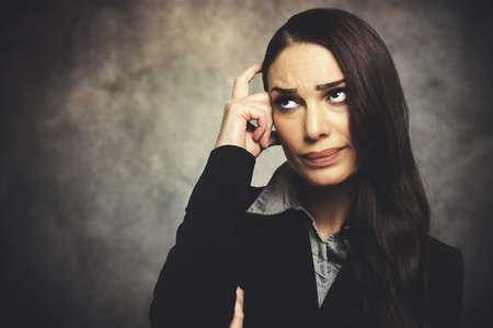 Portrait of a beautiful young woman thinkingの写真素材