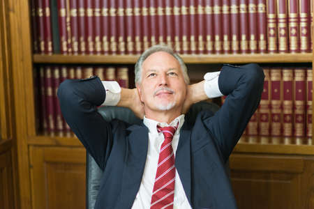 Senior businessman relaxing in his officeの写真素材