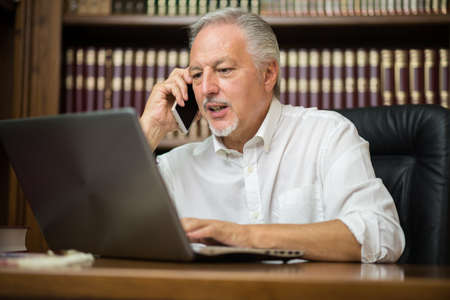 Man using laptop in his home officeの写真素材