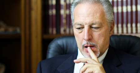 Portrait of a thoughtful manager in his officeの写真素材