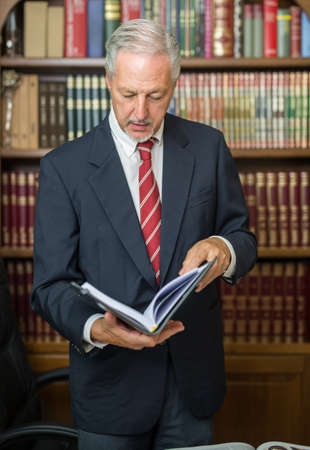 Senior businessman reading book