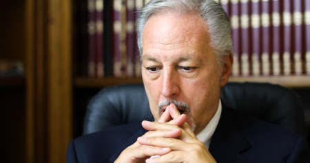 Portrait of a thoughtful manager in his officeの写真素材