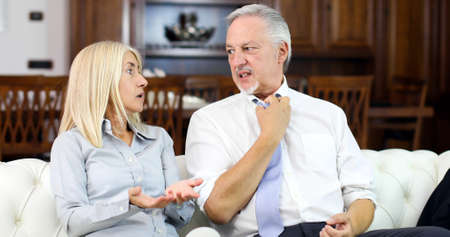 Senior couple fighting on a sofaの写真素材