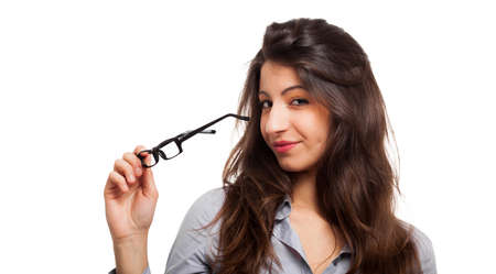 Smiling woman holding a pair of glassesの写真素材