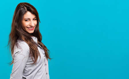 Smiling businesswoman on a blue backgroundの写真素材