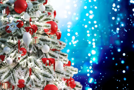 Christmas tree against a glittery luminous backgroundの写真素材