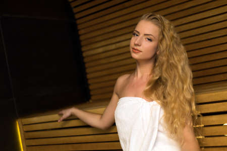 Woman relaxing in a sauna in a wellness centerの写真素材