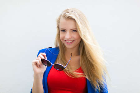 Portrait of smiling caucasian businesswoman holding glassesの写真素材